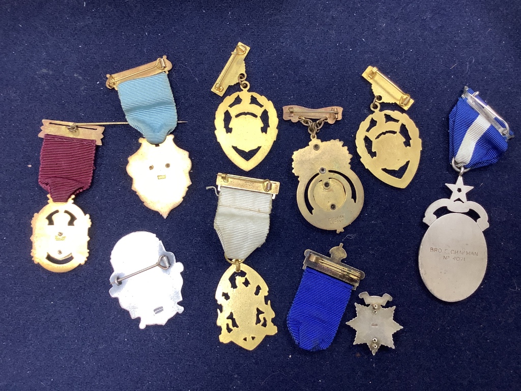 A collection of assorted enamel badges and nursing badges